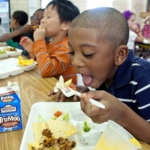 Boy eating school lunch.