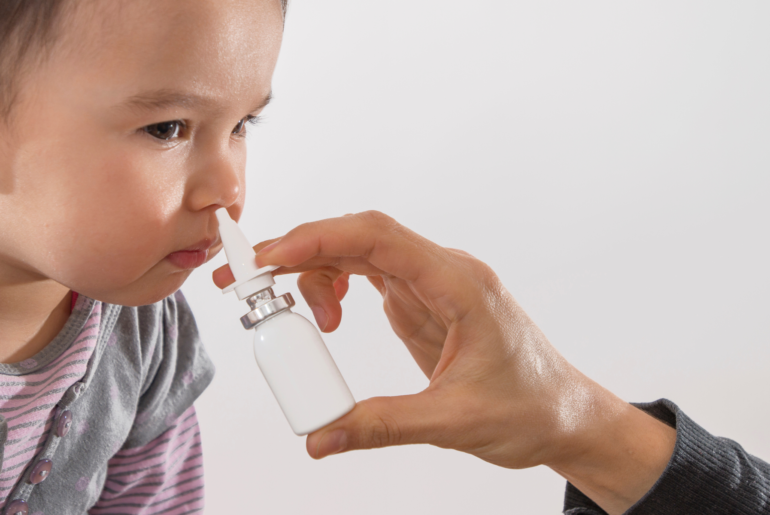child getting vaccine via nasal spray
