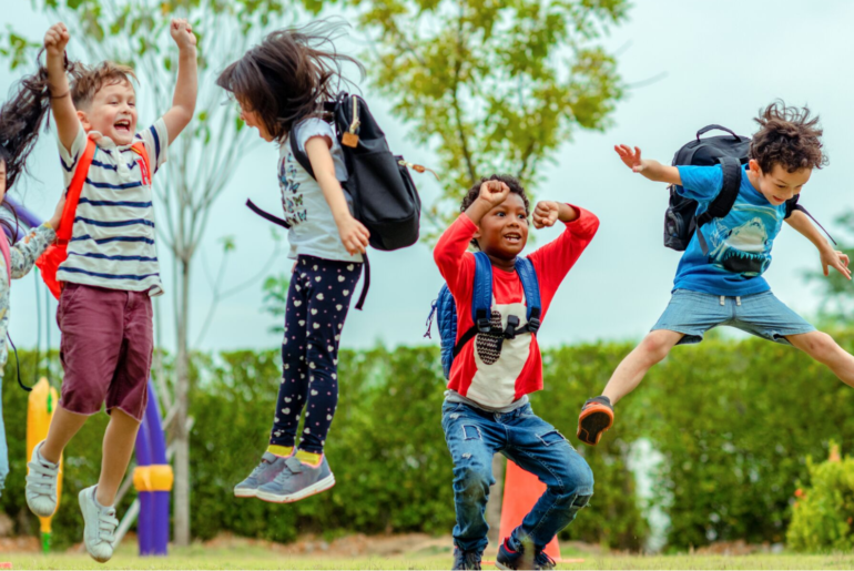 Children playing and jumping in a playground.