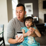 Father and daughter take a silly selfie.