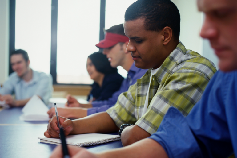 College students taking notes.