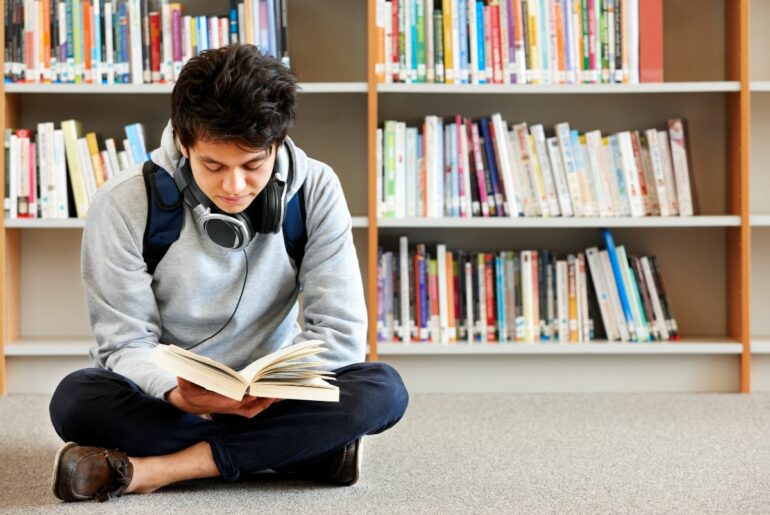 Teen reading in library